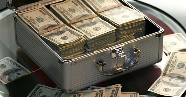 Open briefcase full of bundles of dollar banknotes